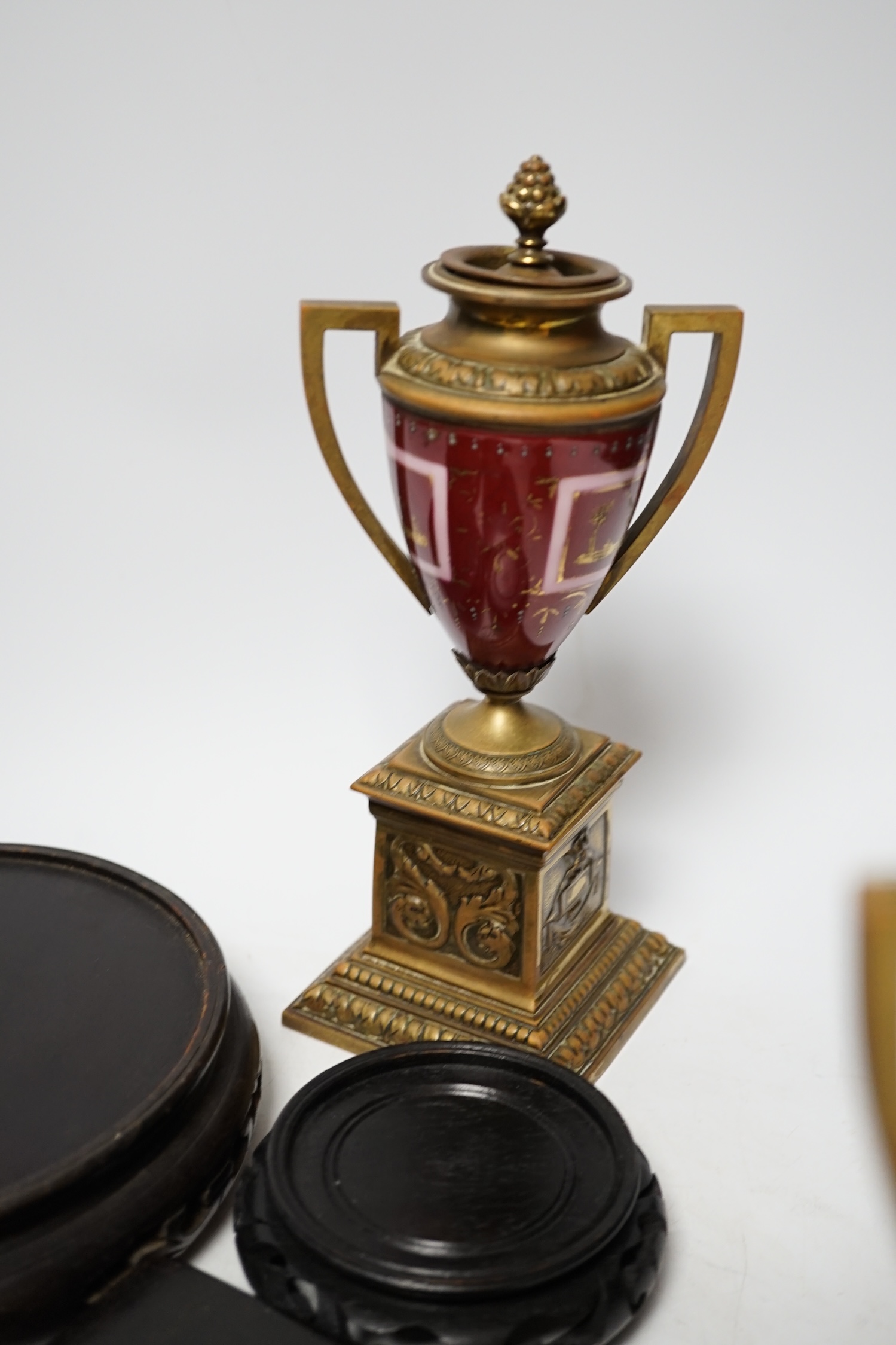 A pair of Vienna style brass mounted urns with enamelled classical scenes and six various Chinese carved hardwood stands, 23cm high